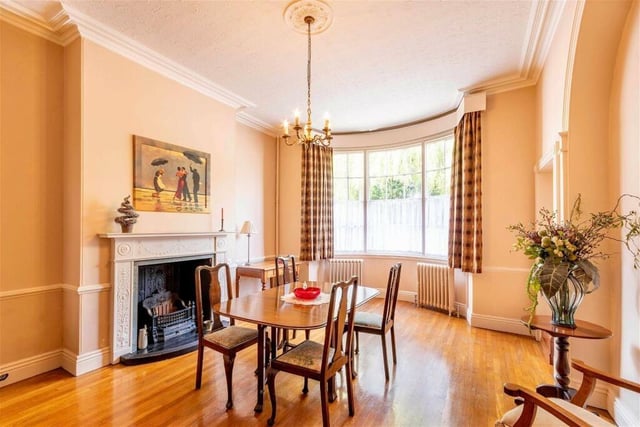 Natural light floods in to the dining room, with its fireplace and period decorative features.