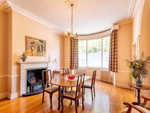 Natural light floods in to the dining room, with its fireplace and period decorative features.