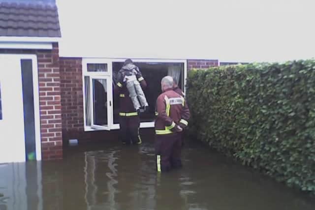 Mason is pictured being rescued in the 2007 floods