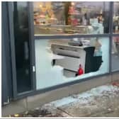 Raiders used a brick to smash into DN1 Delicatessen to escape with champagne, fine wines and expensive foods.