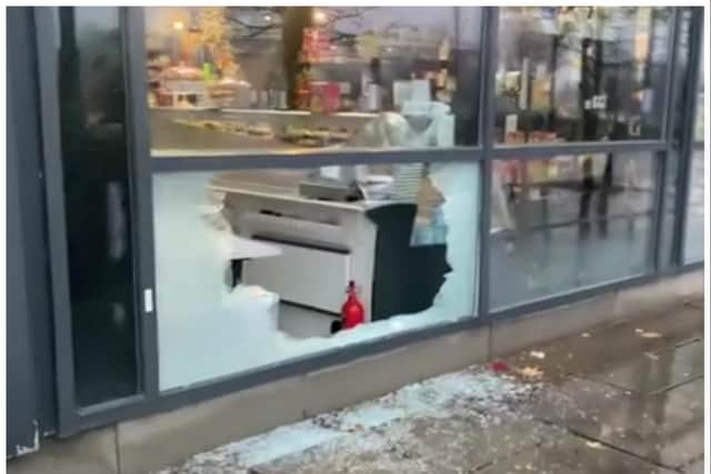 Raiders used a brick to smash into DN1 Delicatessen to escape with champagne, fine wines and expensive foods.