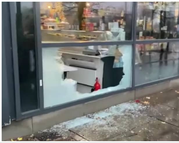 Raiders used a brick to smash into DN1 Delicatessen to escape with champagne, fine wines and expensive foods.