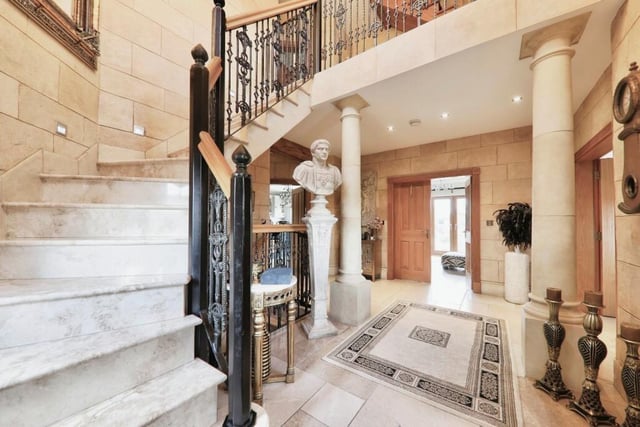 The palatial entrance hall to the Sykehouse home has a gallery, and a magnificent marble staircase.