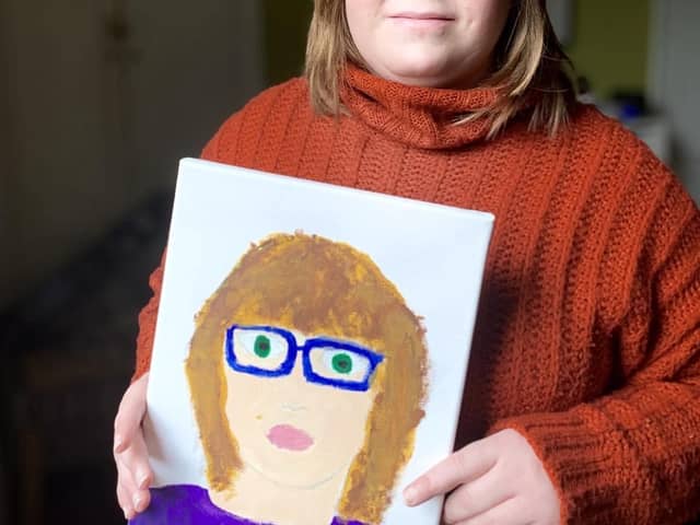 Emily Head, who attends the Artistic Spectrum group, showcases her self-portrait.