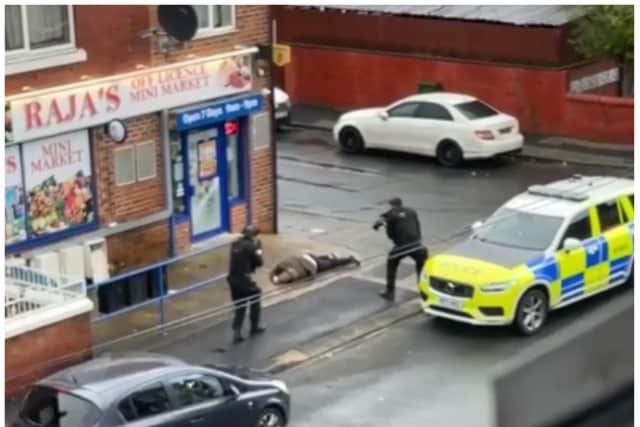 Police surround the suspected gunman after a shooting incident in Rockingham Road. (Photo/Video: Marcus Faith).