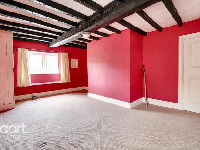 A first floor bedroom with mullion windows.