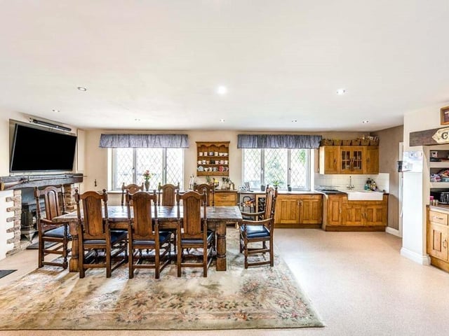An open kitchen with diner, with a feature fireplace.