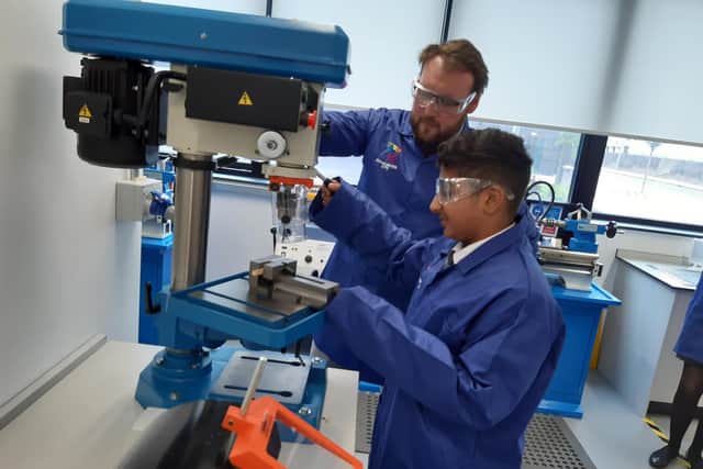 Luke Price, lead teacher of engineering, working with a pupil on the engineering equipment at Doncaster Univerity Technical College