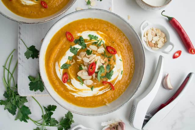 A bowl of soup with garlic as a key ingredient