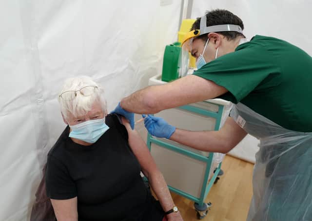 A pensioner receives the Covid-19 vaccine