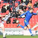 Doncaster's Adam Long wins a header against Grimsby.