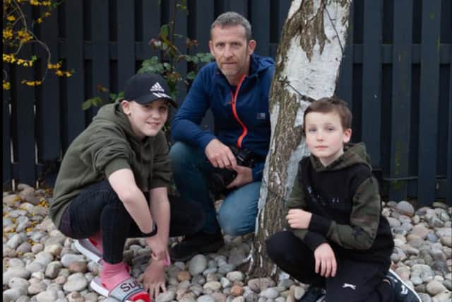 Steve Nightingale with sons Louie and Ben, in the garden where they are dong their own safari
