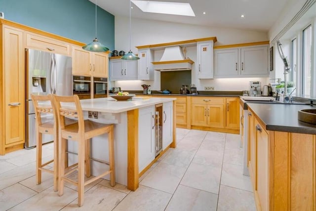 The modern kitchen, with central island unit and breakfast bar.