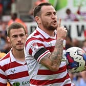 Doncaster's Lee Tomlin celebrates his penalty against Mansfield.