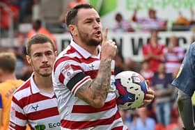 Doncaster's Lee Tomlin celebrates his penalty against Mansfield.