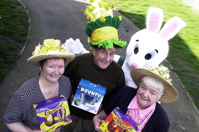 Easter bonnet winner June Hepworth (left), second-placed Kenneth Robinson, and third-placed Betty McDonnell, are pictured with their Carcroft Asda prizes. Warren the bunny, alias 16 year-old Claire Birkinshaw, was on hand to add to the Easter flavour of the event, held at the Chestnut View Communal Hall, Edward Road, Carcroft, in 2002