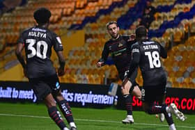 Doncaster Rovers' Ben Close celebrates his goal with Tavonga Kuleya and Deji Sotona.