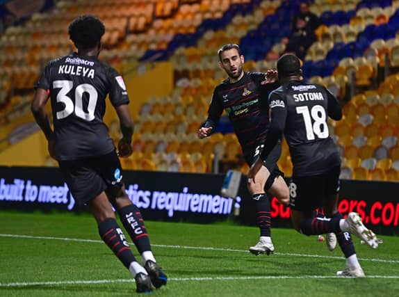 Doncaster Rovers' Ben Close celebrates his goal with Tavonga Kuleya and Deji Sotona.