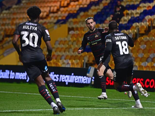 Doncaster Rovers' Ben Close celebrates his goal with Tavonga Kuleya and Deji Sotona.