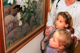 Faye and Cara Hughes looking at a painting in 1997 with their grandmother Mary Pickin.