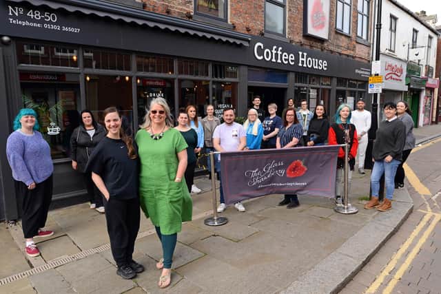 Bev Georgiou, owner and Antonia Georgiou, manager, pictured with staff members outside The Glass Strawberry Coffee House. Picture: NDFP-11-05-21-GlassStrawberry 1-NMSY