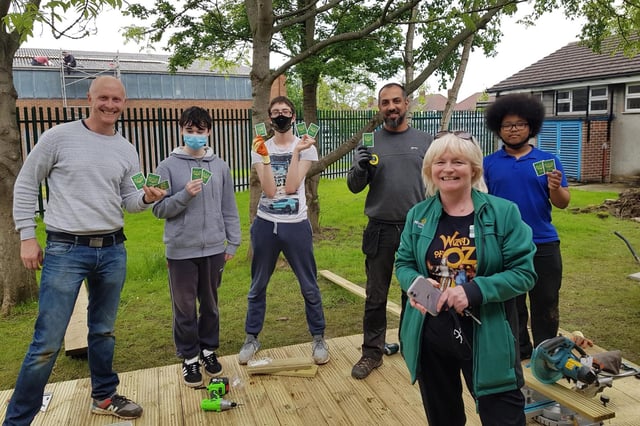Mike Peebles, business development director, Volunteer It Yourself (left) and Caroline Cordon from Morrison’s with students from Harrison College