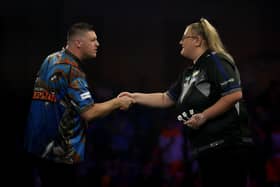 LONDON, ENGLAND - DECEMBER 19: Daryl Gurney of Northern Ireland shakes hands with Beau Greaves of England before their match on Day Nine of the 2025/26 Paddy Power World Darts Championship at Alexandra Palace on December 19, 2025 in London, England.  (Photo by Andrew Redington/Getty Images)