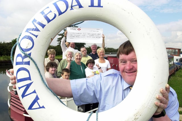 In 2000 Doncaster Town Moor Golf Club presented £1,400 to Conisbrough Social Education centre, to put towards the re-fit of its canal boat Andromeda. Our picture shows Neil Cooper (front), with Jim Pickersgill (back, left), Chairman of the Conisbrough SEC Boat Support Group, receiving the cheque from Lol Sanderson (back, right), president of the Golf Club and the rest of the presentation party. The boat is moored at the Blue Water Marina, Thorne.