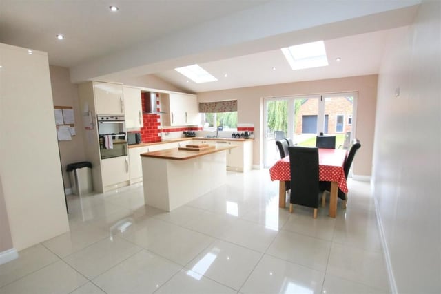 The open plan living kitchen has underfloor heating, and bi-fold doors out to the garden.