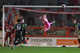 Doncaster Rovers goalkeeper Stuart Moore punches clear.