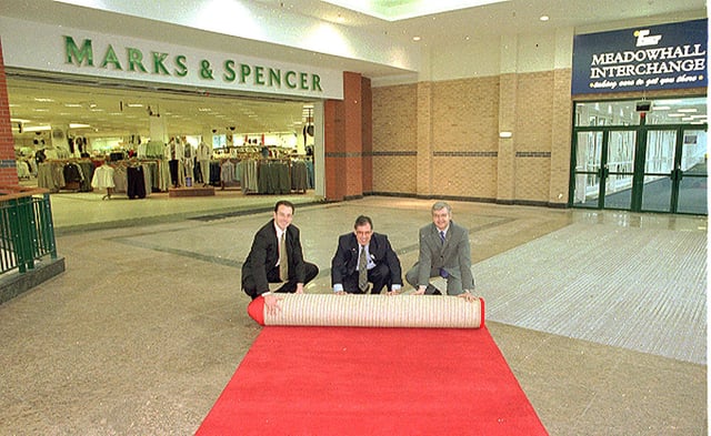 Marks & Spencer Meadowhall rolled out the red carpet for customers at the Meadowhall Centre for the opening of the new link between the Interchange bridge at the front of the store in 1999. Left to right, Darren Pearce, Finance Manager at Meadowhall Centre, Peter Walker, South Yorkshire Passenger Executive and Stefan Andrejczuk, M & S Meadowhall Store Manager.