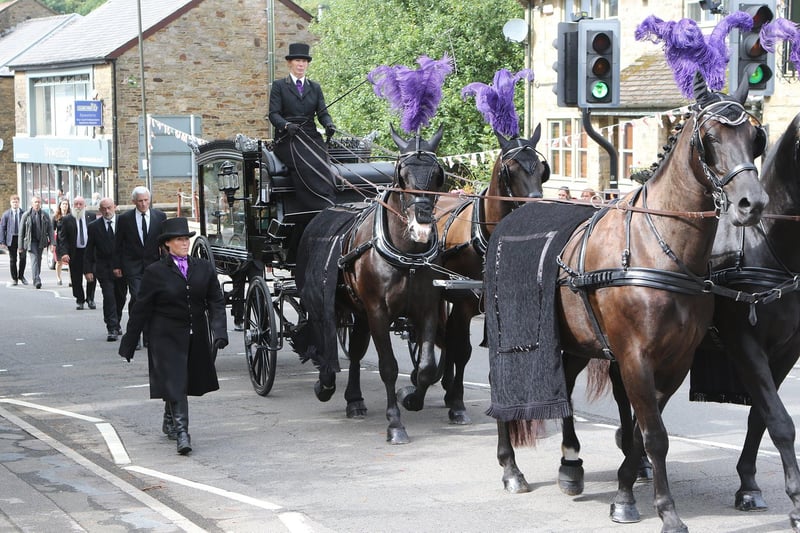 The horse drawn hearse arrives at the church