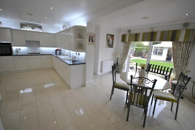 The open plan, high spec dining kitchen has doors out to the garden.
