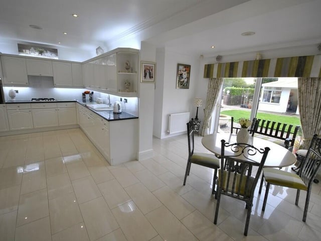 The open plan, high spec dining kitchen has doors out to the garden.