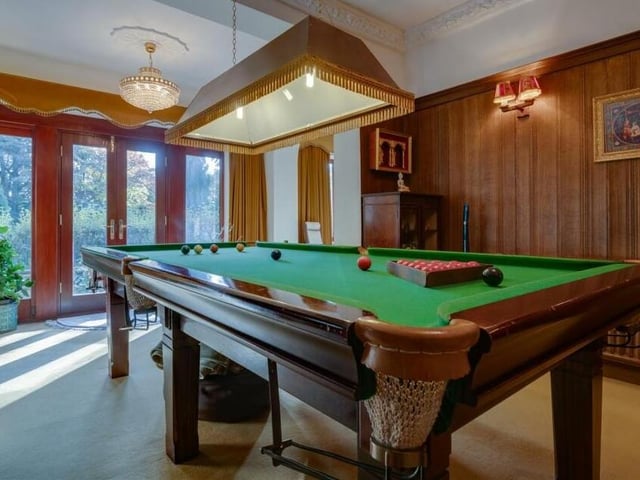 A snooker room, with doors leading outside.