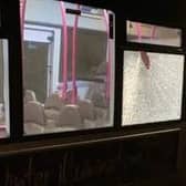 Bus services were cancelled after yobs threw a brick through a bus window.