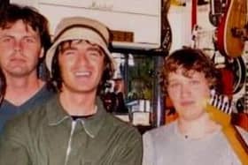 Noel Gallagher on a visit to Doncaster's Music Ground vintage guitar store in the 1990s, alongside a young Michael Price (right). Photo: Michael Price.