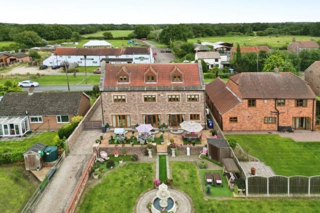 An expansive landscaped garden is perfect for entertaining, with a wide terrace and a brick built gazebo.