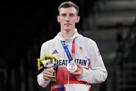 Silver medallist Bradly Sinden poses on the podium after the taekwondo men’s -68kg bouts at the Tokyo 2020 Olympic Games. Photo by JAVIER SORIANO/AFP via Getty Images