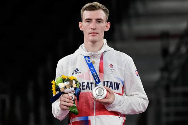 Silver medallist Bradly Sinden poses on the podium after the taekwondo men’s -68kg bouts at the Tokyo 2020 Olympic Games. Photo by JAVIER SORIANO/AFP via Getty Images
