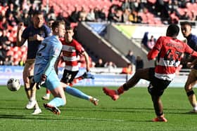 Hakeeb Adelakun slots home the opening goal in Rovers' win over Wimbledon.