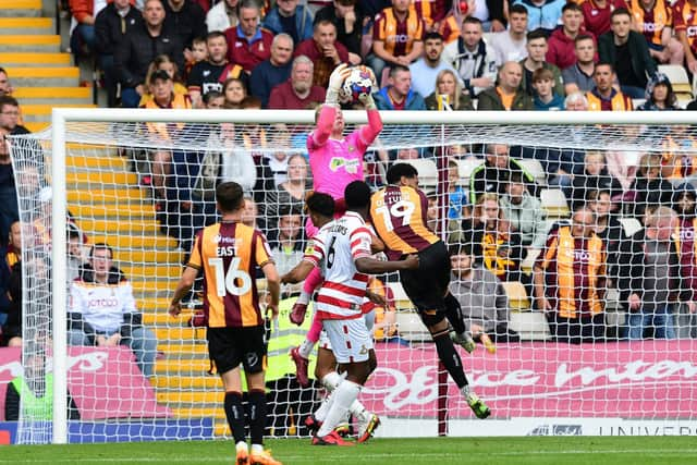 Doncaster's Jonathan Mitchell catches under pressure against Bradford City. Photo: Howard Roe/AHPIX LTD.