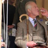 King Charles III enjoys a dram during the Mey Highland Games at the John O'Groats Showground in Caithness. Photo by Robert MacDonald/PA Wire