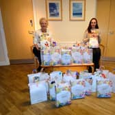 Katie, right, handing over the packs to Maureen