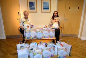 Katie, right, handing over the packs to Maureen