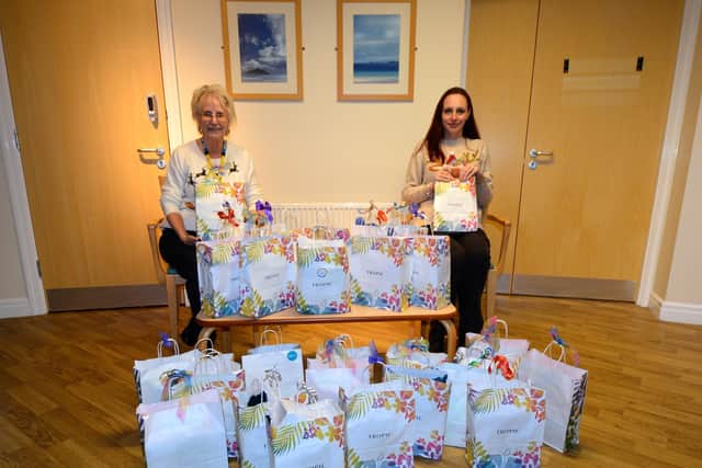 Katie, right, handing over the packs to Maureen
