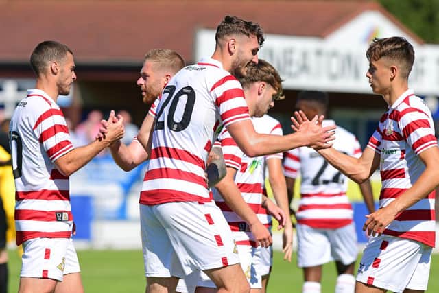 Doncaster's players celebrate Josh Andrews' goal against Nuneaton Borough.