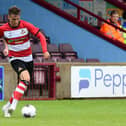 Doncaster Rovers' George Broadbent looks to pass the ball against Scunthorpe United.