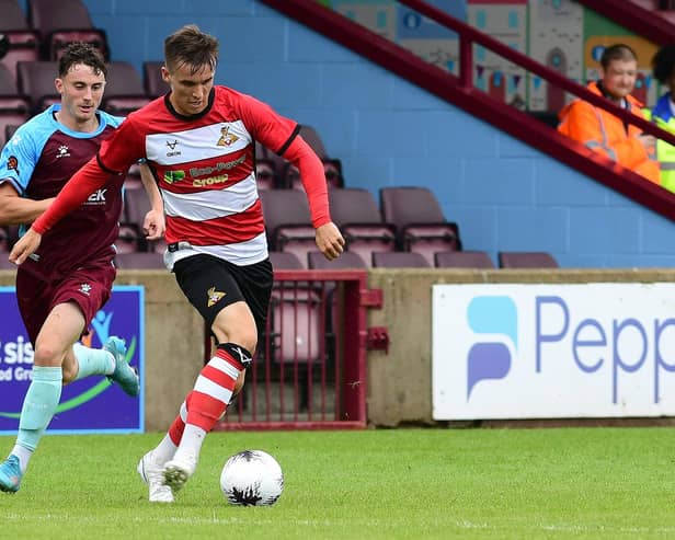 Doncaster Rovers' George Broadbent looks to pass the ball against Scunthorpe United.