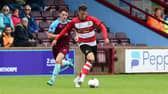 Doncaster Rovers' George Broadbent looks to pass the ball against Scunthorpe United.